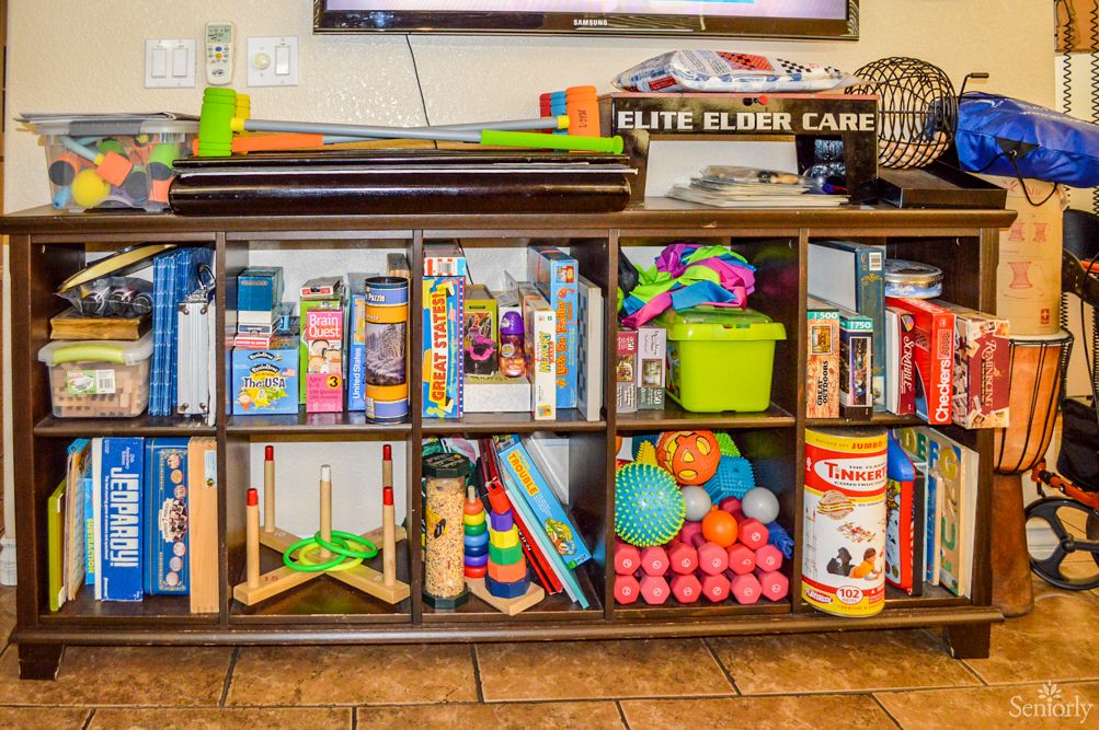 A well-organized shelf filled with toys, games, and books.