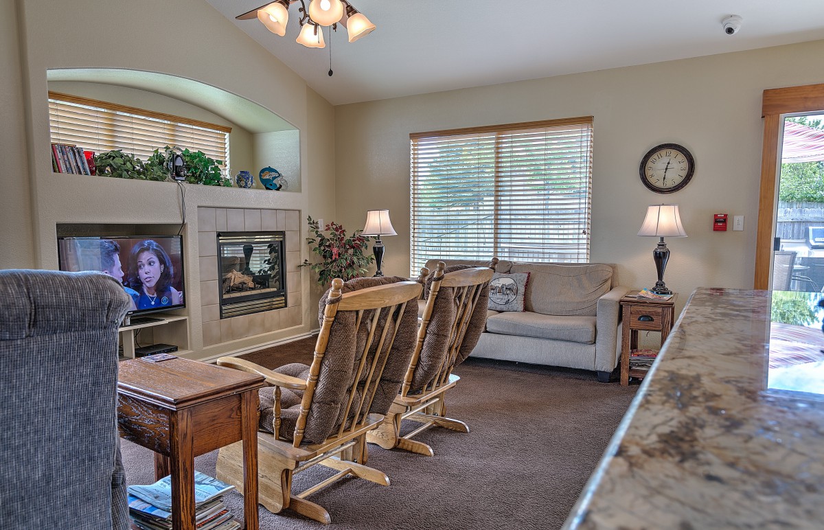 Cozy living room with comfortable seating, a television, and soft lighting.