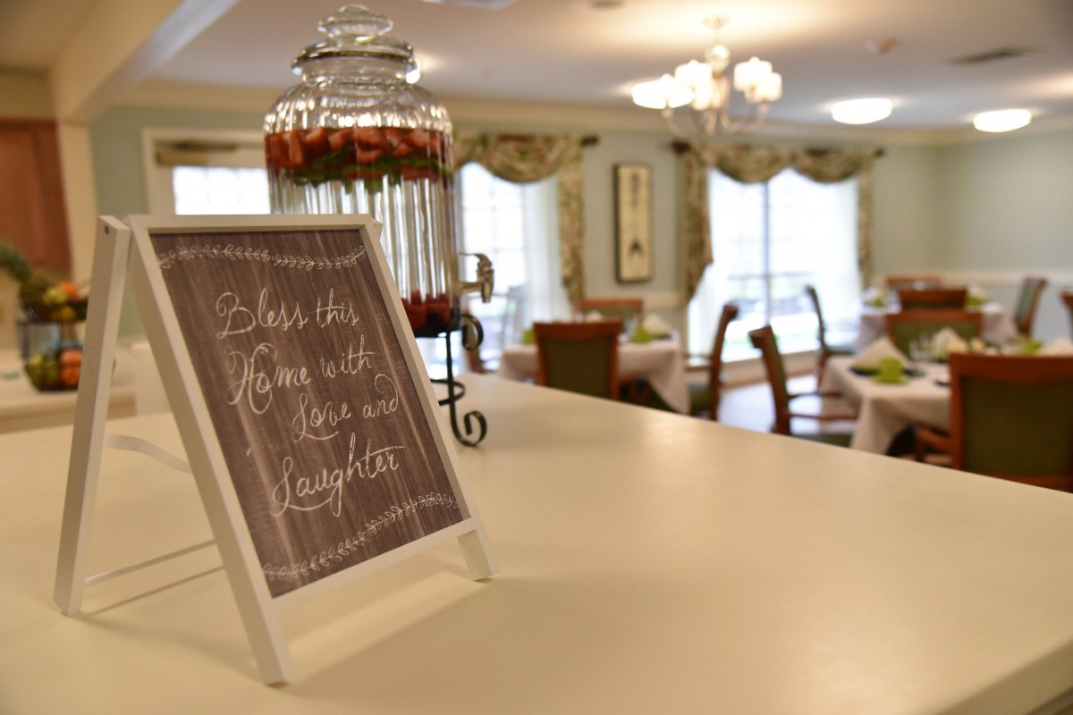 A cozy room with a decorative sign displaying an inspirational quote on a table.