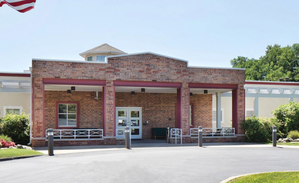 A brick building with an entrance, likely a school.
