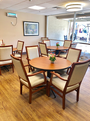A cozy dining area featuring wooden tables and comfortable chairs.