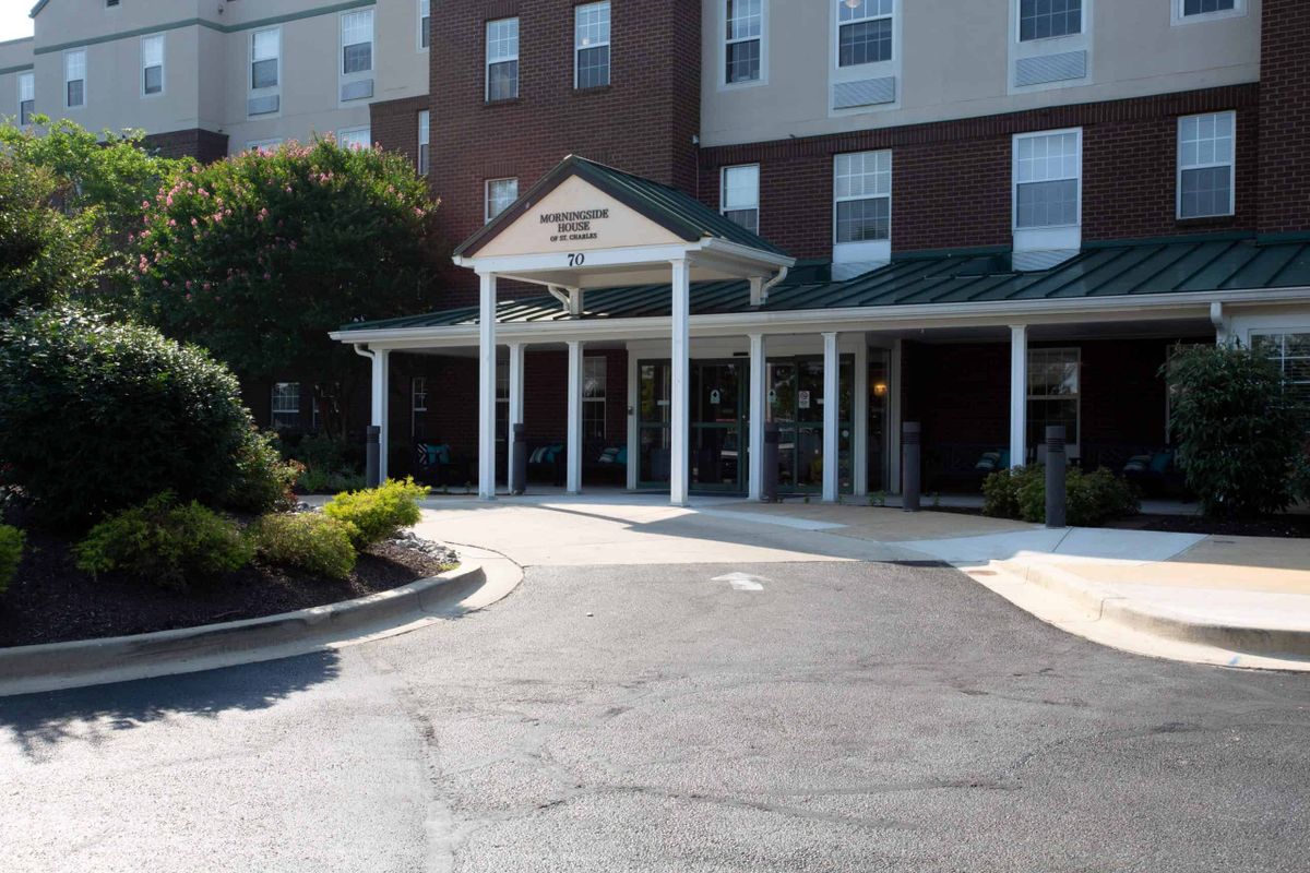 Front entrance of a hotel building with a covered walkway.