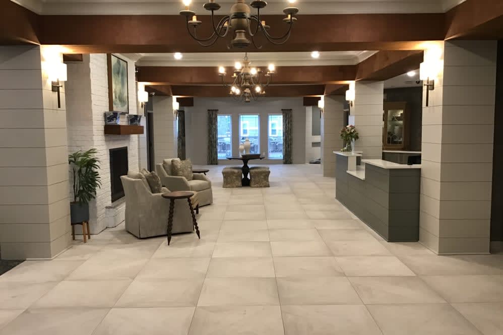 Modern lobby with seating area and chandelier lighting.