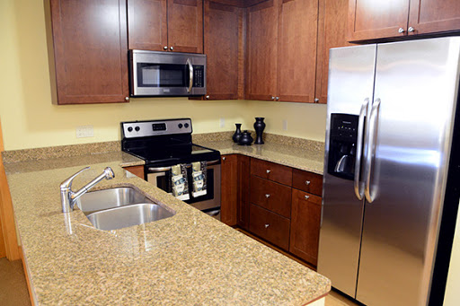 A modern kitchen featuring stainless steel appliances and elegant granite countertops.