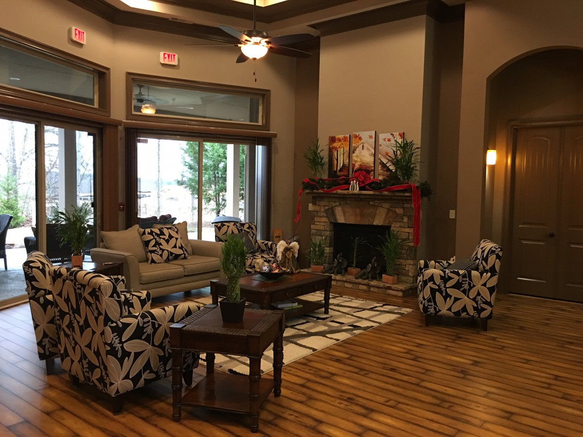 A cozy living room with modern decor, featuring a fireplace and comfortable seating.