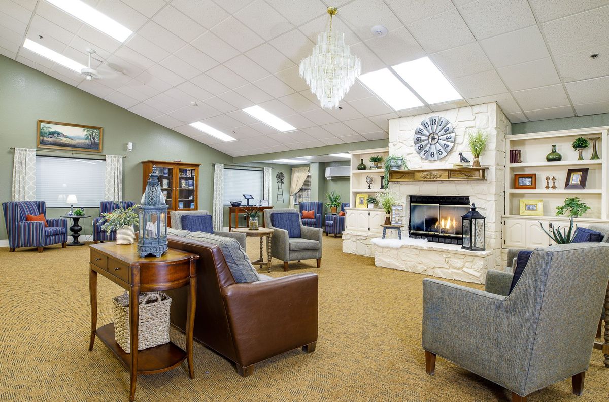 A modern lounge area with comfortable seating, a fireplace, and elegant decor.