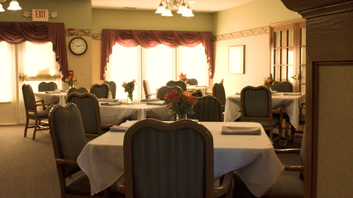A cozy dining area featuring elegantly set tables and soft lighting.