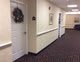 A carpeted hallway with decorated doors.