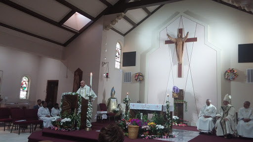 A priest delivering a sermon in a church during a religious service.