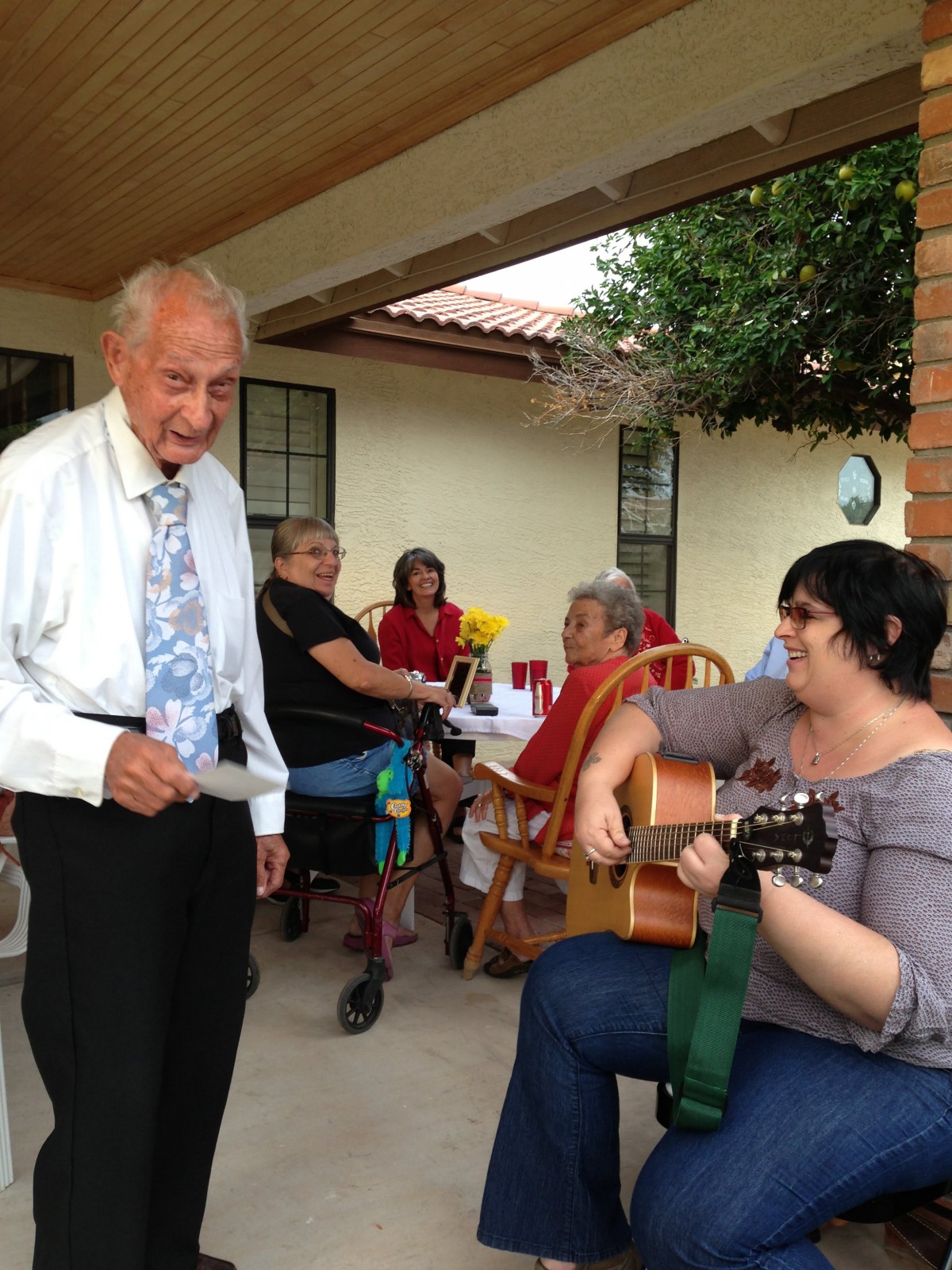A joyful outdoor gathering with music and conversation.