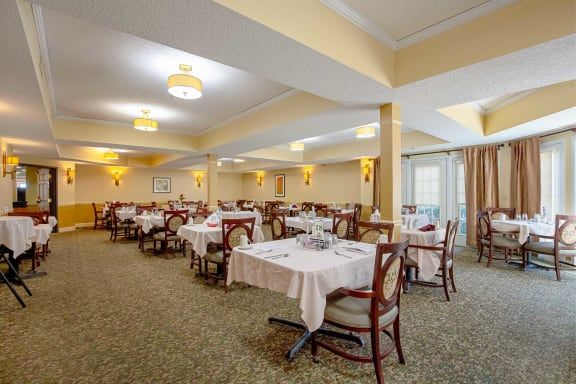 A spacious restaurant dining area with neatly arranged tables and chairs.