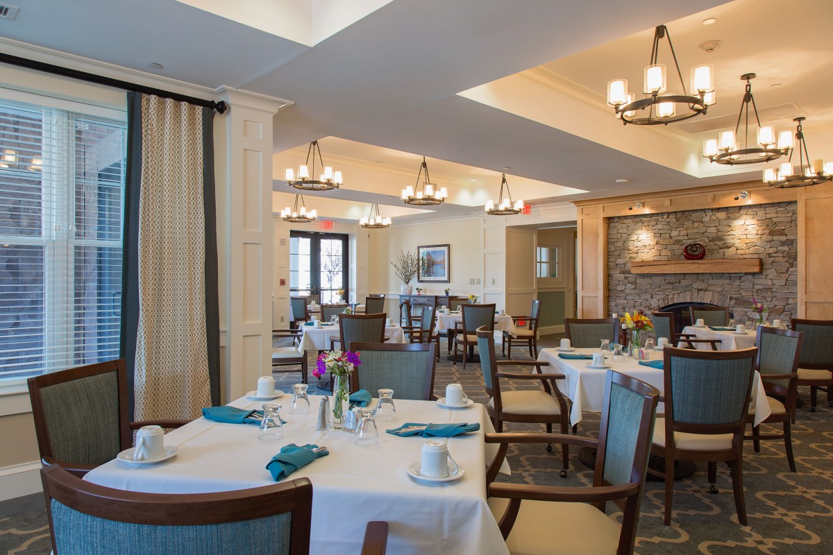 A well-arranged dining room with neatly set tables and comfortable seating.