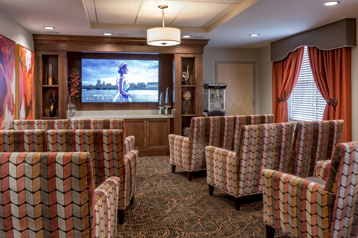 A cozy home theater with comfortable seating and a large screen.