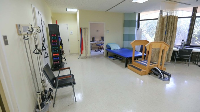 A physical therapy room equipped with exercise tools and treatment areas.