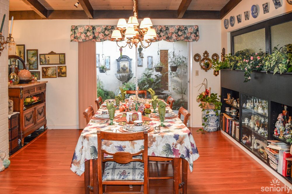 A cozy dining room with a beautifully set table and warm decor.