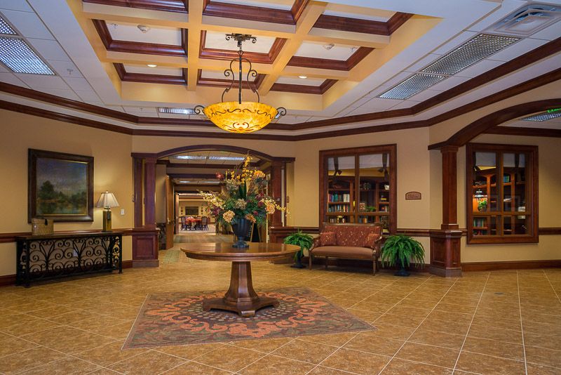An elegant hotel lobby with a decorative chandelier and stylish furnishings.