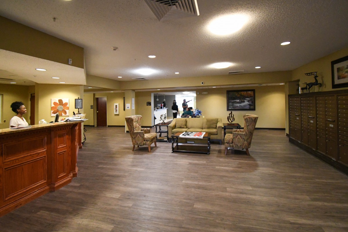 A modern lobby with a reception area and comfortable seating.
