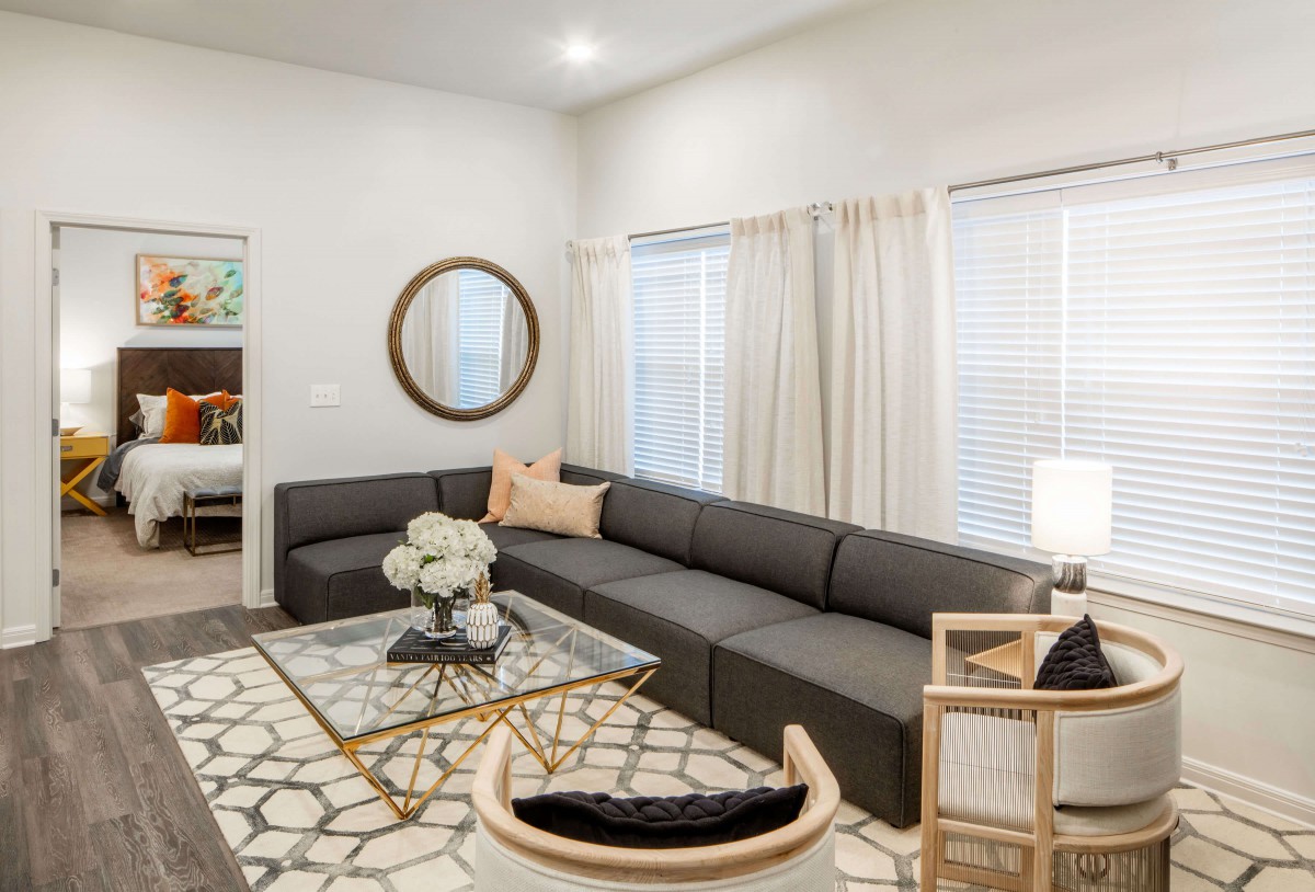 A modern living room with a large sectional sofa and stylish decor.