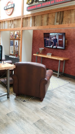 A cozy living space featuring a leather armchair and TV.