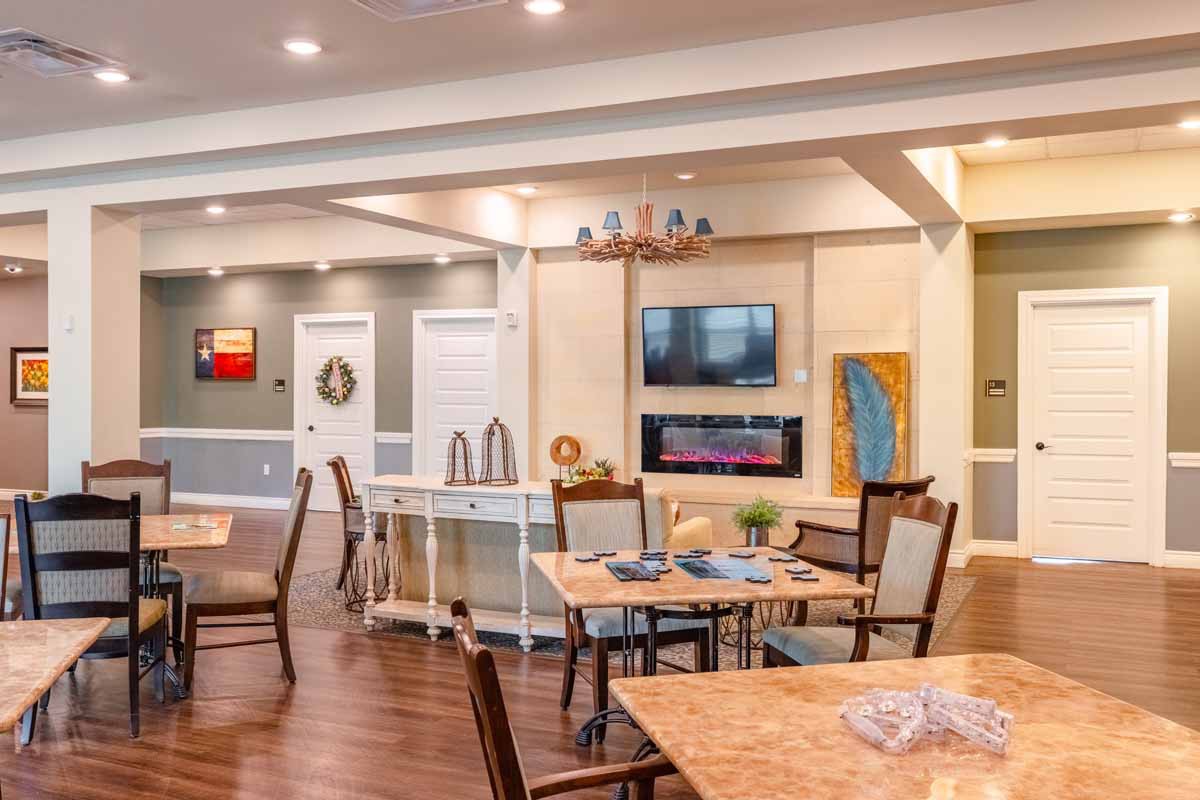 A modern, open-concept living and dining area with stylish furniture and warm lighting.