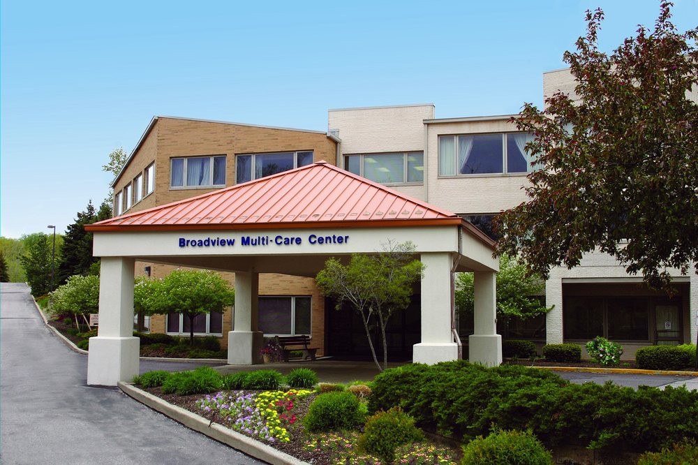 The entrance of a healthcare center with a landscaped front.