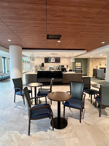 A spacious and modern cafe area featuring seating arrangements for guests.