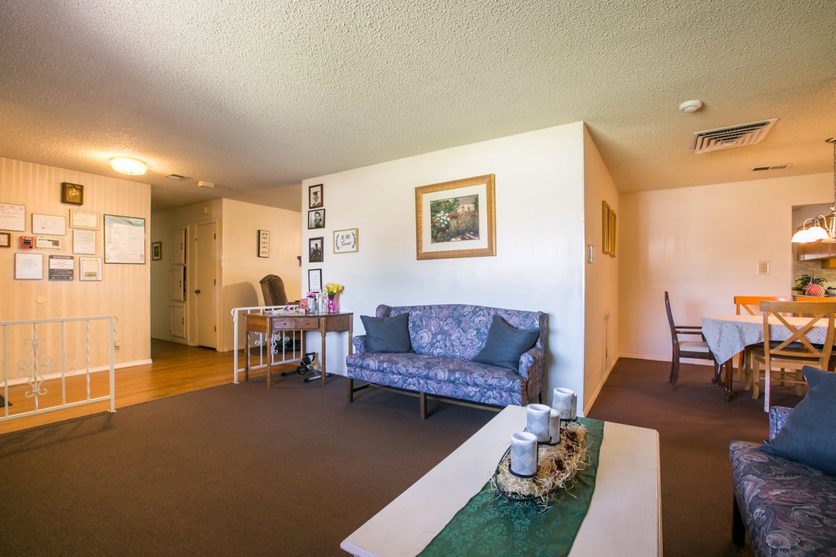 A cozy living room with a couch, table, and wall art.