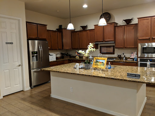 A modern kitchen featuring wooden cabinets, granite countertops, and contemporary appliances.