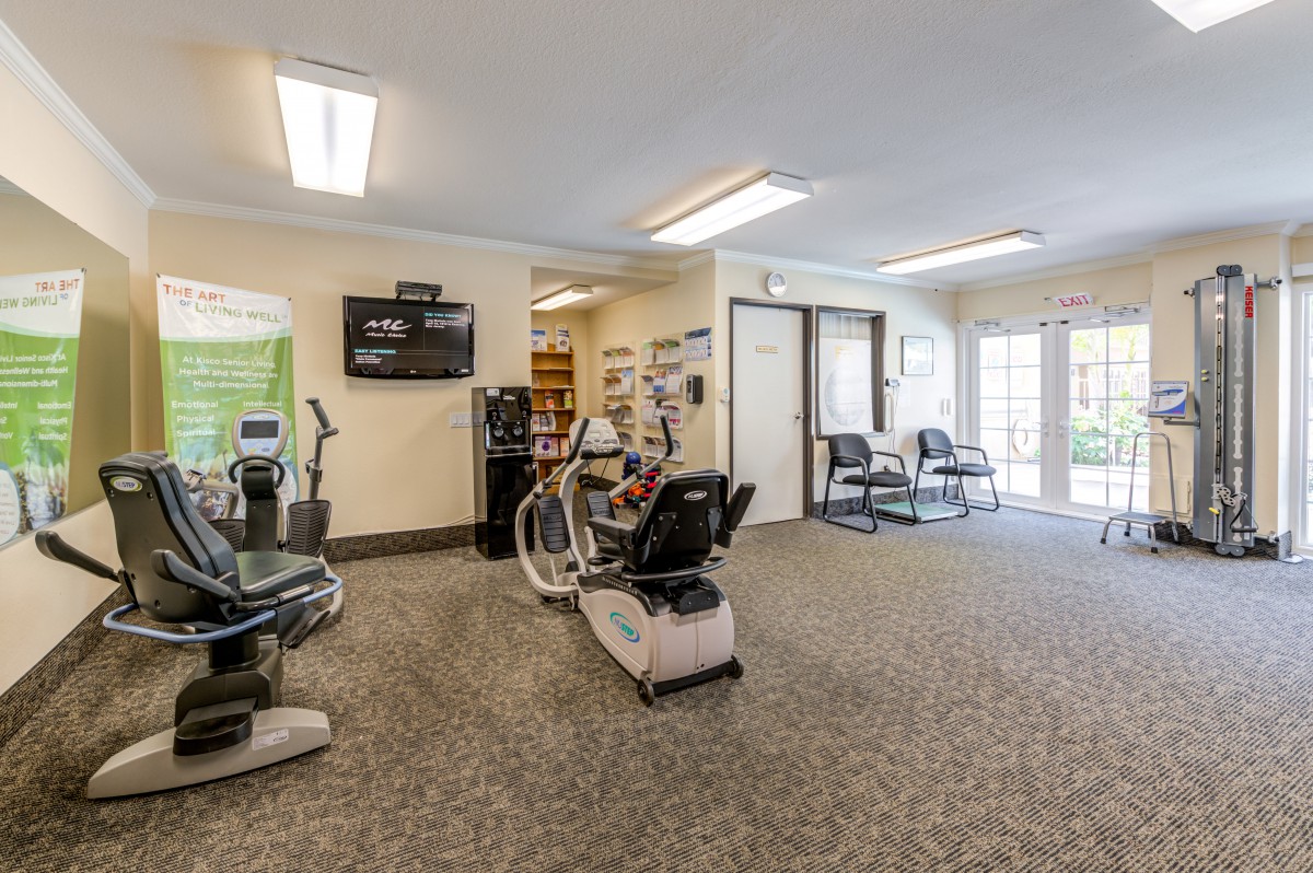 A well-equipped gym with exercise machines and fitness equipment in a spacious indoor setting.