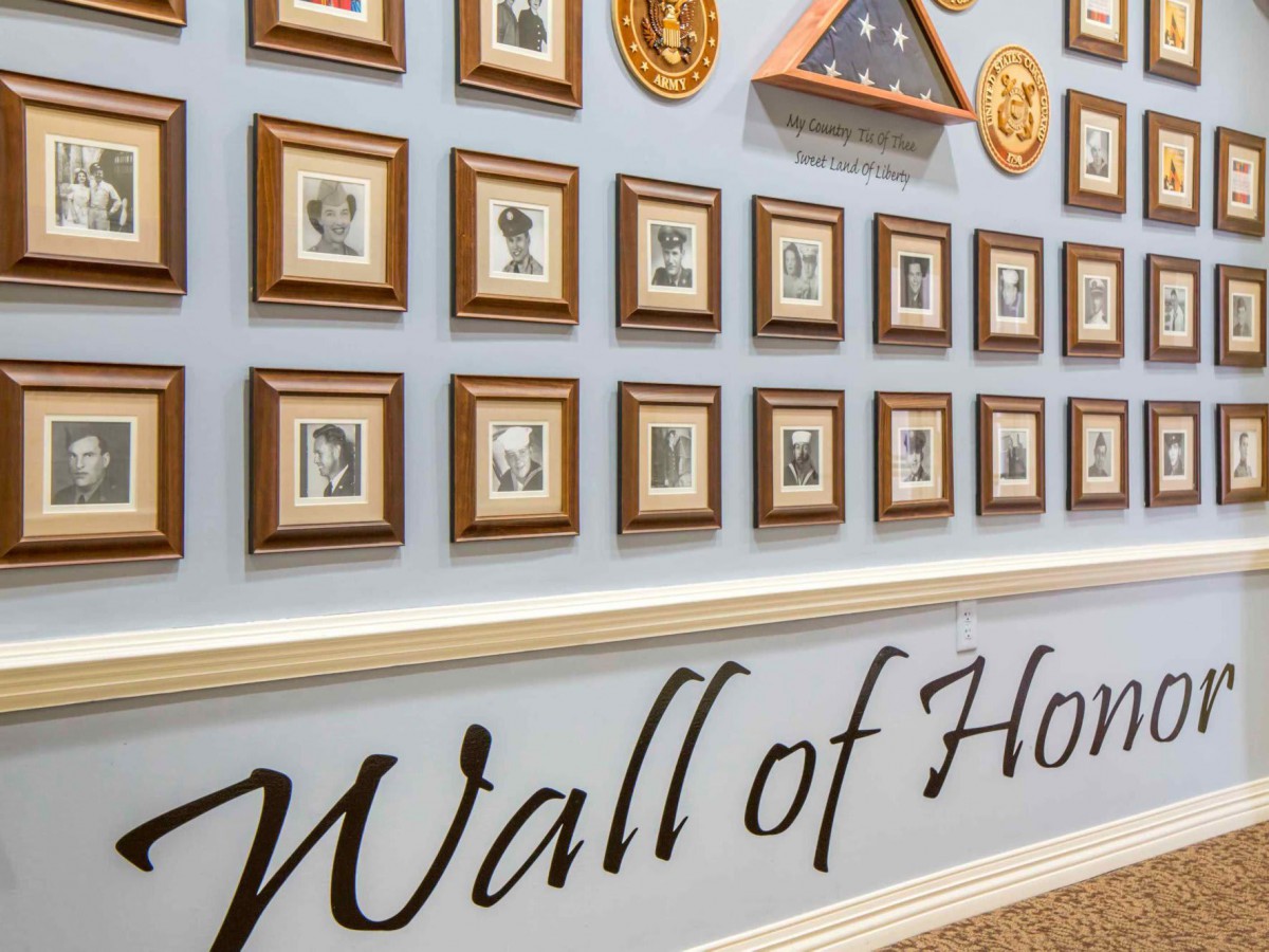 A Wall of Honor featuring framed photos and memorabilia dedicated to veterans.