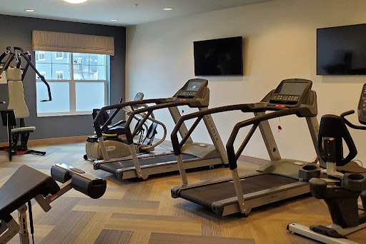 A well-equipped indoor gym featuring treadmills and an elliptical machine.