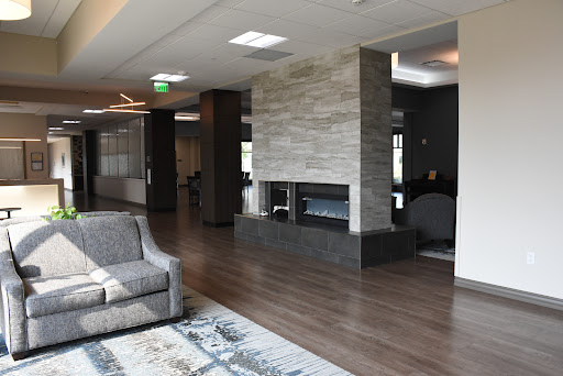 A modern lounge area featuring a stylish fireplace and comfortable seating.