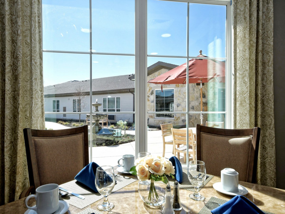 Elegant dining setup with a view of the outdoor patio.