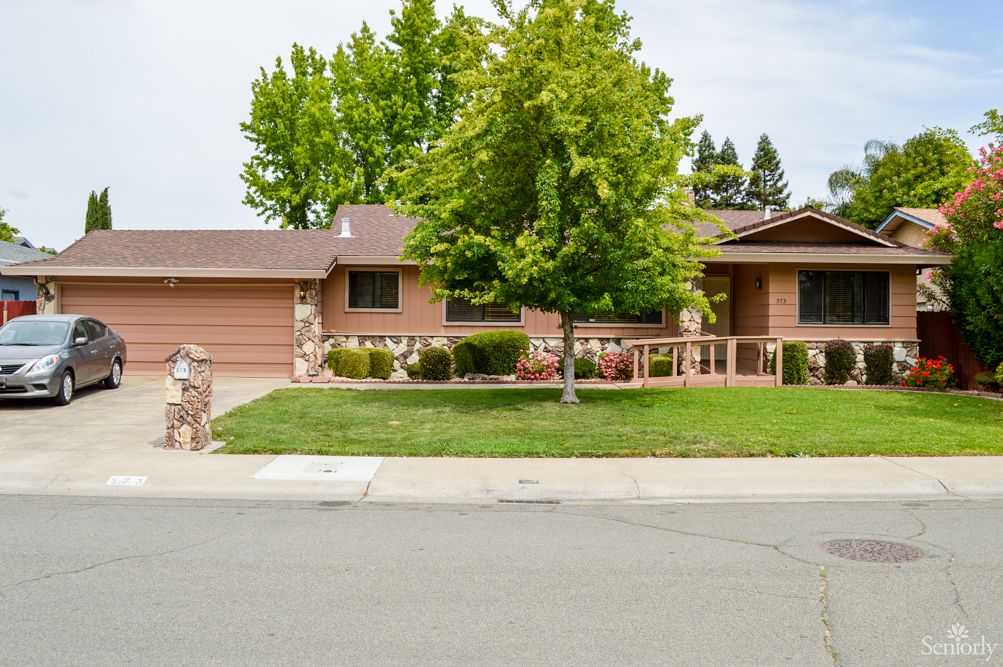 A single-story suburban house with a landscaped front yard and driveway.