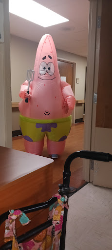 An inflatable costume of a famous cartoon character adds a playful touch to the hallway.