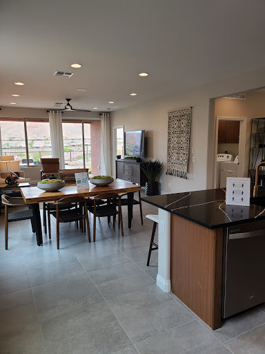 A spacious and modern dining area with an open kitchen, featuring a large table and comfortable seating.