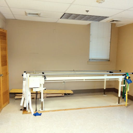 A minimalistic view of a hospital room featuring a medical table.