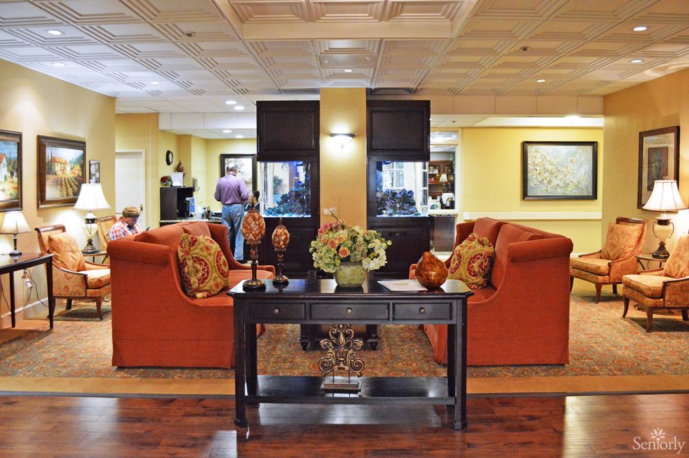 A cozy living room with orange sofas and modern decor.