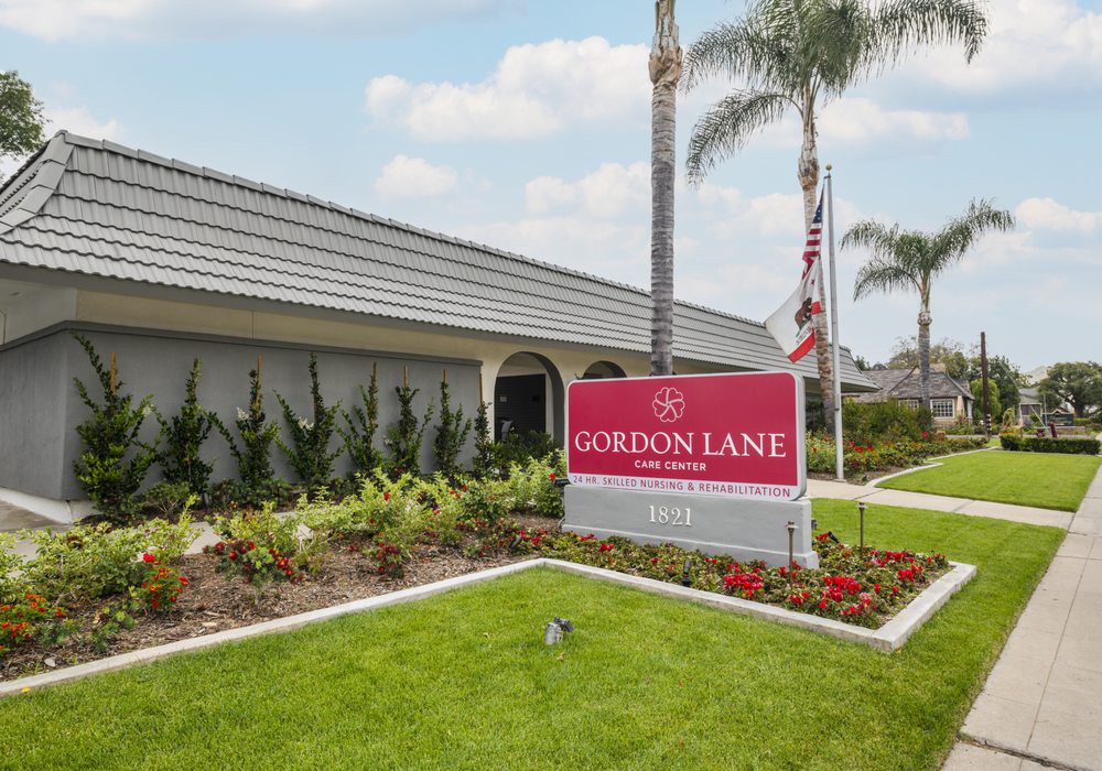 Exterior view of the Gordon Lane nursing home with a prominent sign and well-maintained landscaping.