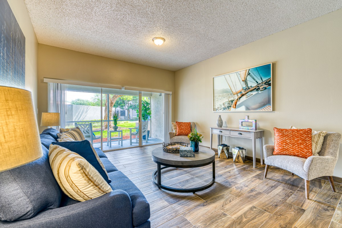 A cozy living room with modern furniture and large windows.