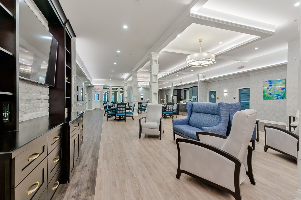A spacious and modern living room with elegant furniture and lighting.