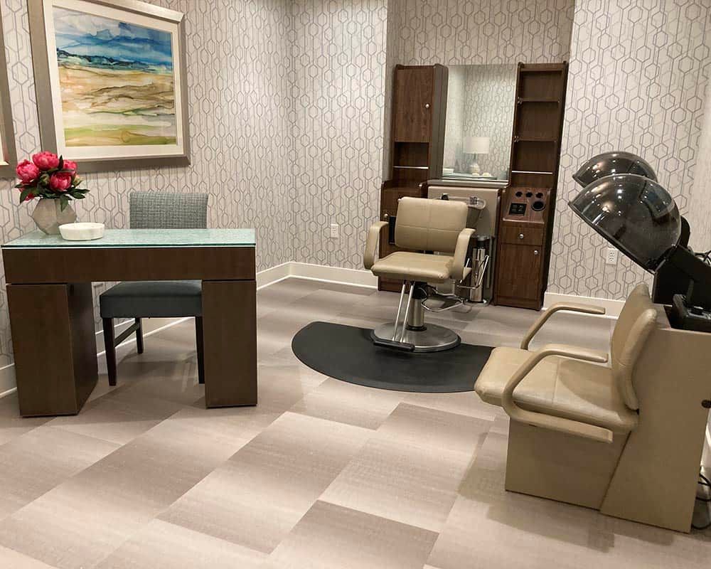 A modern hair salon with comfortable seating and sleek design.