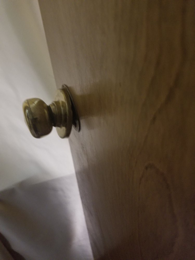 A close-up view of a doorknob on a wooden door.