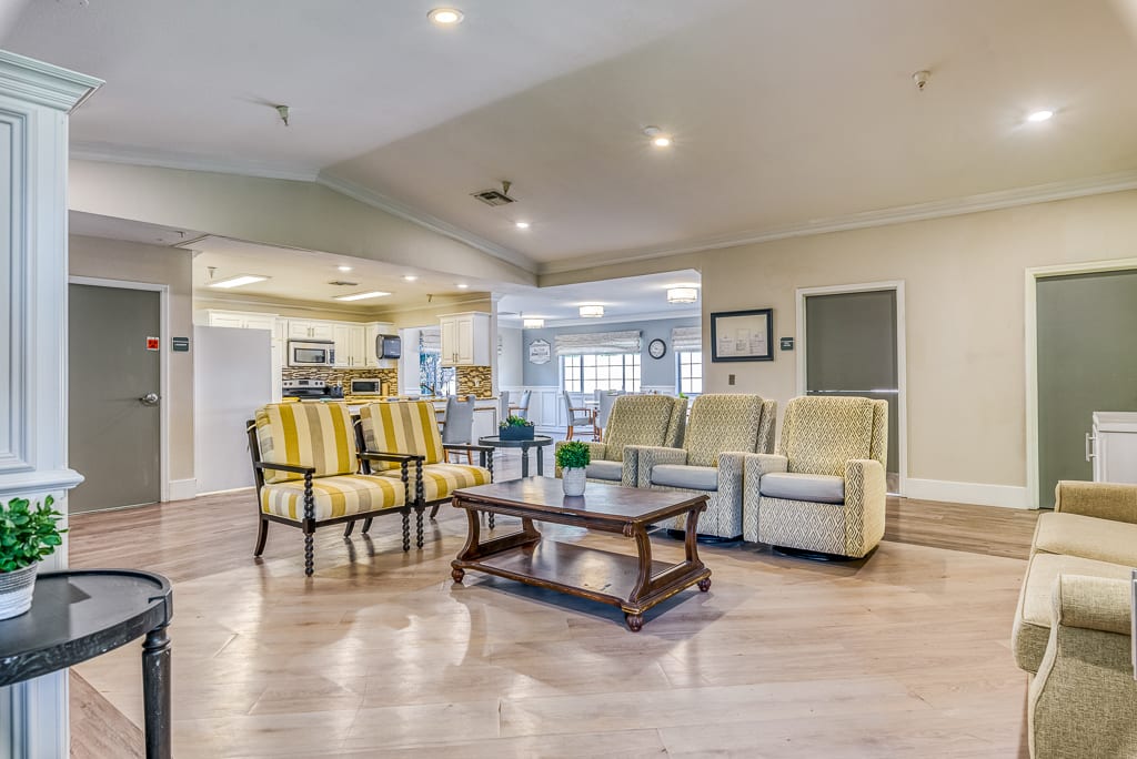 A spacious and modern living room featuring comfortable seating and elegant decor.