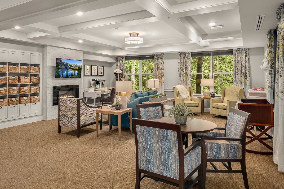 A cozy and elegantly decorated living room with comfortable seating and ample natural light.