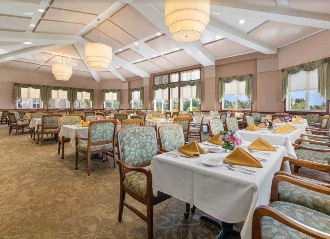 Elegant dining area with neatly arranged tables and decorative lighting.