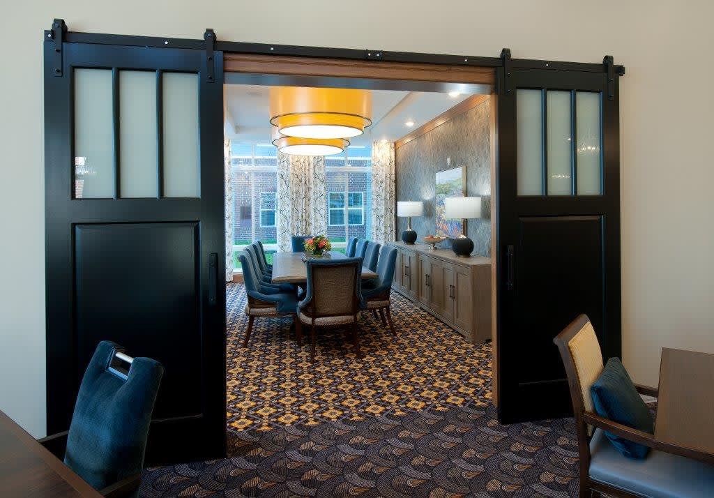 A modern dining or conference room with elegant decor and lighting.