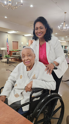 A warm moment between a caregiver and an elderly woman, showcasing support and companionship.