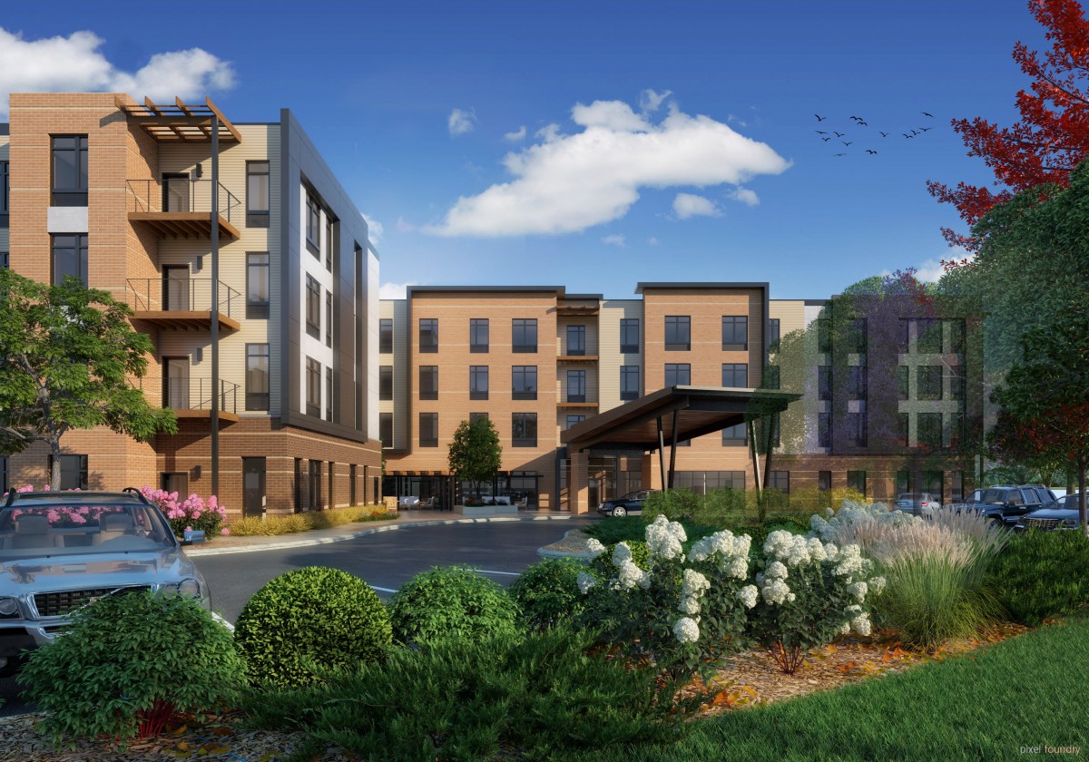 A modern apartment complex surrounded by landscaped gardens on a clear day.