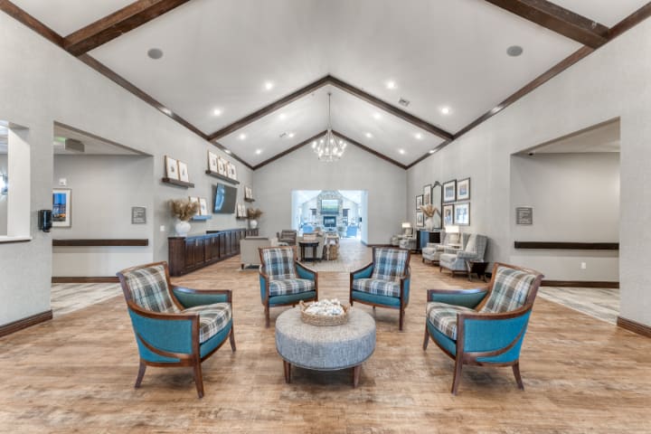 A modern living room with a central seating area and elegant decor.